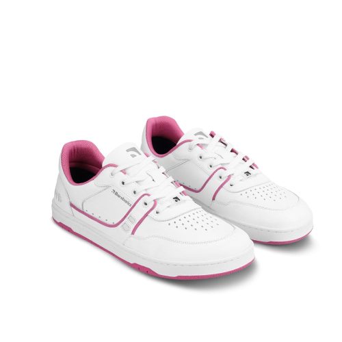 A photo Barebarics Arise chunky leather sneaker in white with pink and white soles and white laces. Shoes are perforated on the sides and toe box and have pink detailing on the soles, both sides of the shoe, and the lining. Both shoes are shown here facing diagonally right against a white background. #color_white-raspberry-pink