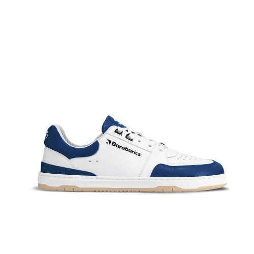 A photo of Barebarics Wave white & dark blue classic sneaker. Shoes are white with a dark blue toeguard, tongue, heel guard, and at the ankle opening. Toe box is perforated and the sole is white with tan tread. Barebarics brand name is written on the side. Right shoe is shown here facing right against a white background. #color_white-dark-blue