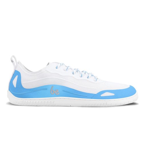 Photo 1 - A photo of Blue Be Lenka Velocity sneakers with white soles, and a harder, light blue material guarding the parimeter of the sole. Sneakers have an active shoe design and blue & white laces, with a pull tab on the heel. Right sneaker is shown facing right here against a white background. Photo 2 - Both shoes are shown on a woman in workout clothes stretching in the cobra position on a yoga mat exposing the sole of the shoe. #color_blue