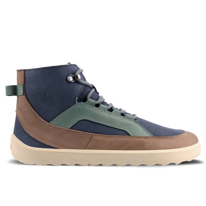 A photo of Be Lenka York ankle lace up boots made from nubuck leather and tan rubber soles. The boots have a navy base color with brown wrapped around the edge of the shoe up the back of the ankle, green angled arch detailing on either side of the laces, and grey laces. The right boot is shown from the right side against a white background. #color_navy-brown-beige