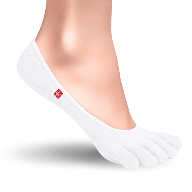 A pair of white Knitido track and trail zero toe socks. Socks are very low cut to be invisible in shoes. Right sock is shown facing right against a white background on a person with the heel up. #color_white