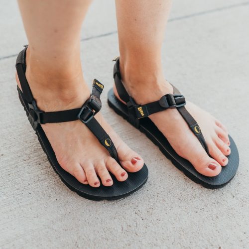 luna mono winged sandals black diagonal on foot both shoes