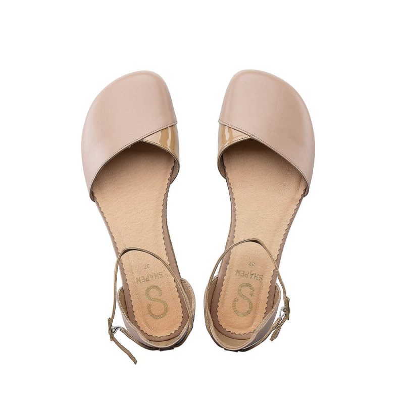 A photo of Beige Shapen Poppy D’orsay dressy flats with a leather upper and rubber soles. The flats have a heel cup and dainty ankle straps, the inside of the sole are a beige color. Both shoes are shown from above against a white background. #color_beige