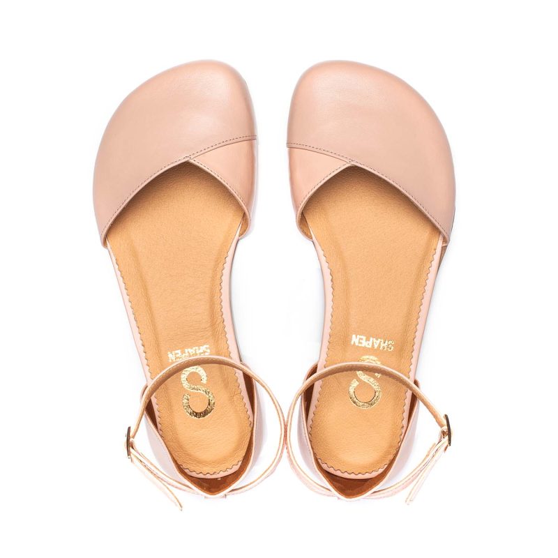 A photo of Shapen Poppy D’orsay dressy flats with a leather upper and rubber soles. The flats are a rose beige color with a heel cup and dainty ankle strap, the inside of the sole are a beige color. Both flats are shown from the top facing up against a white background. #color_rose