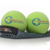 A photo of Tune Up therapy balls made from rubber. The therapy balls are a light green color with therapy ball written on one side and yoga tune up on the other. Both balls are shown sitting on a gray mesh bag against a white background.